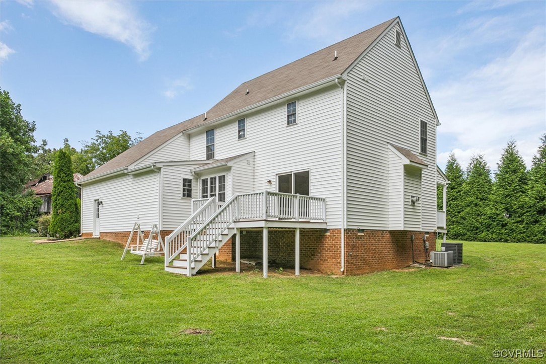 203 Oaktree Road, Unit A Williamsburg, VA 23188 - Photo 42 of 46 Back of property with a wooden deck, central AC un