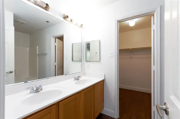 a bathroom with a double vanity sink mirror and