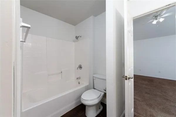 a bathroom with a toilet sink and shower