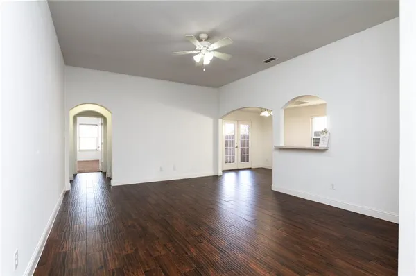 a view of a room with wooden floor and white walls