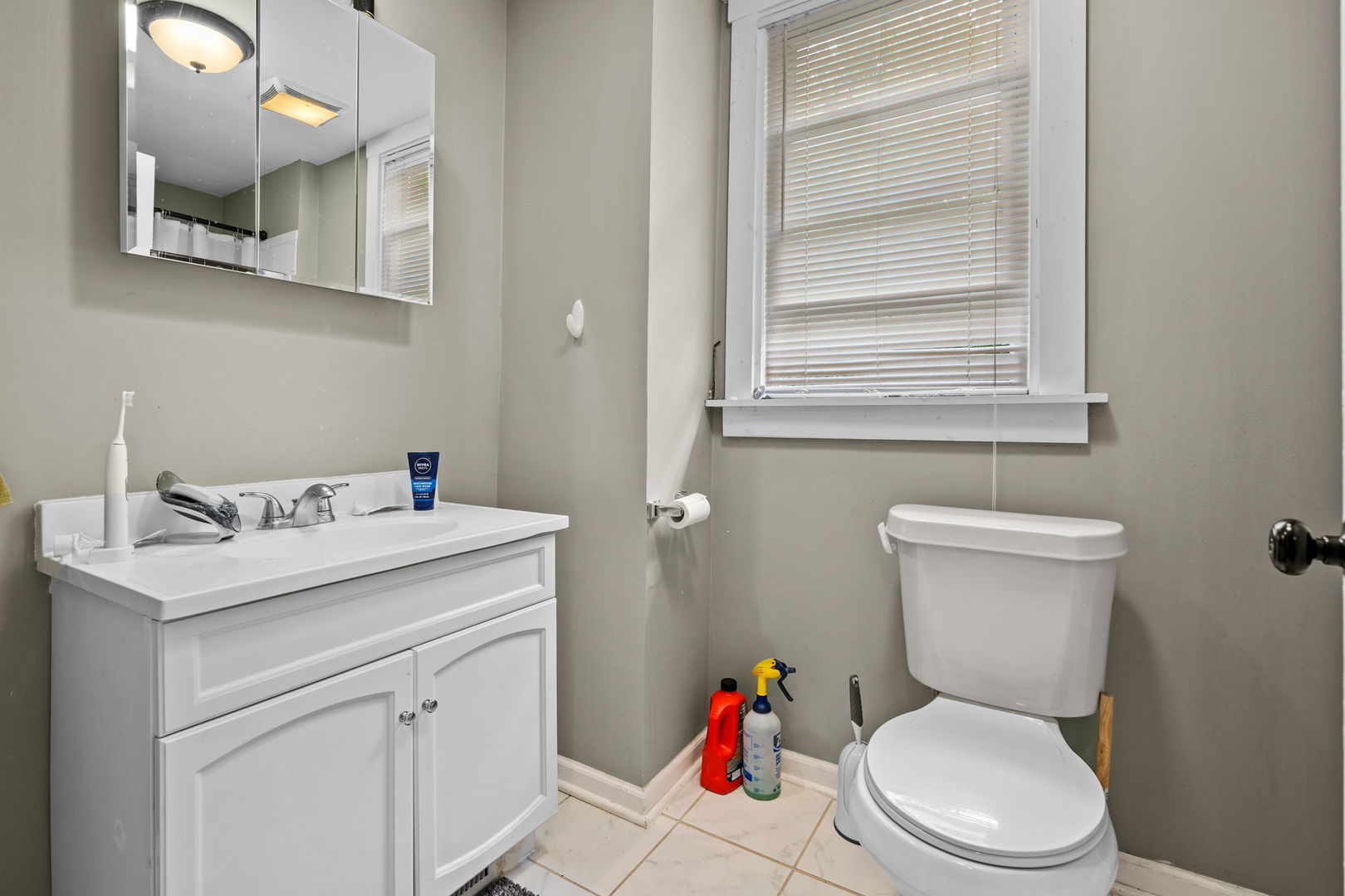 8103 46th Street Lyons, IL 60534 - Photo 13 of 14 a bathroom with a toilet sink and mirror