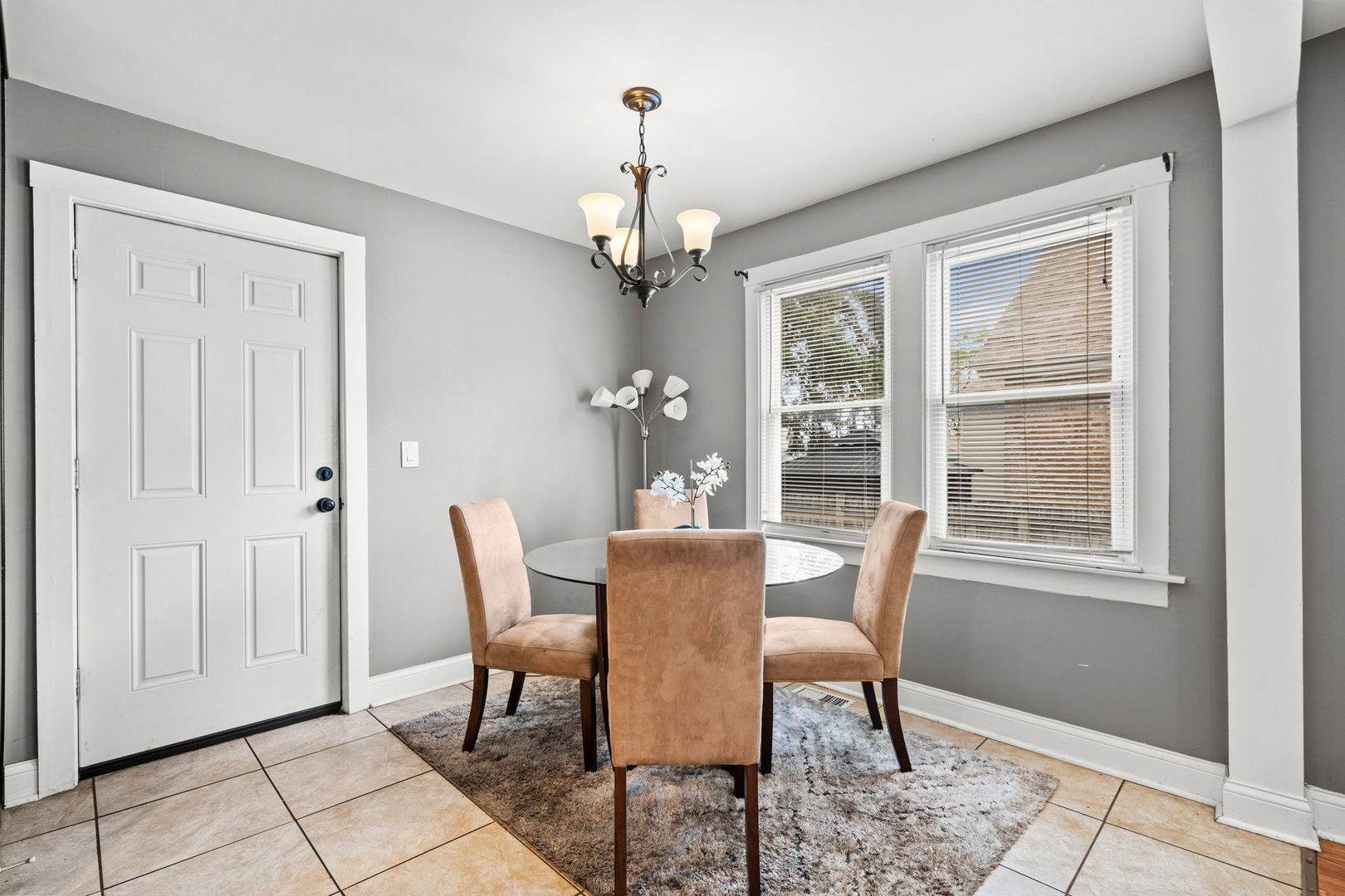 8103 46th Street Lyons, IL 60534 - Photo 7 of 14 a dining room with furniture a chandelier and window