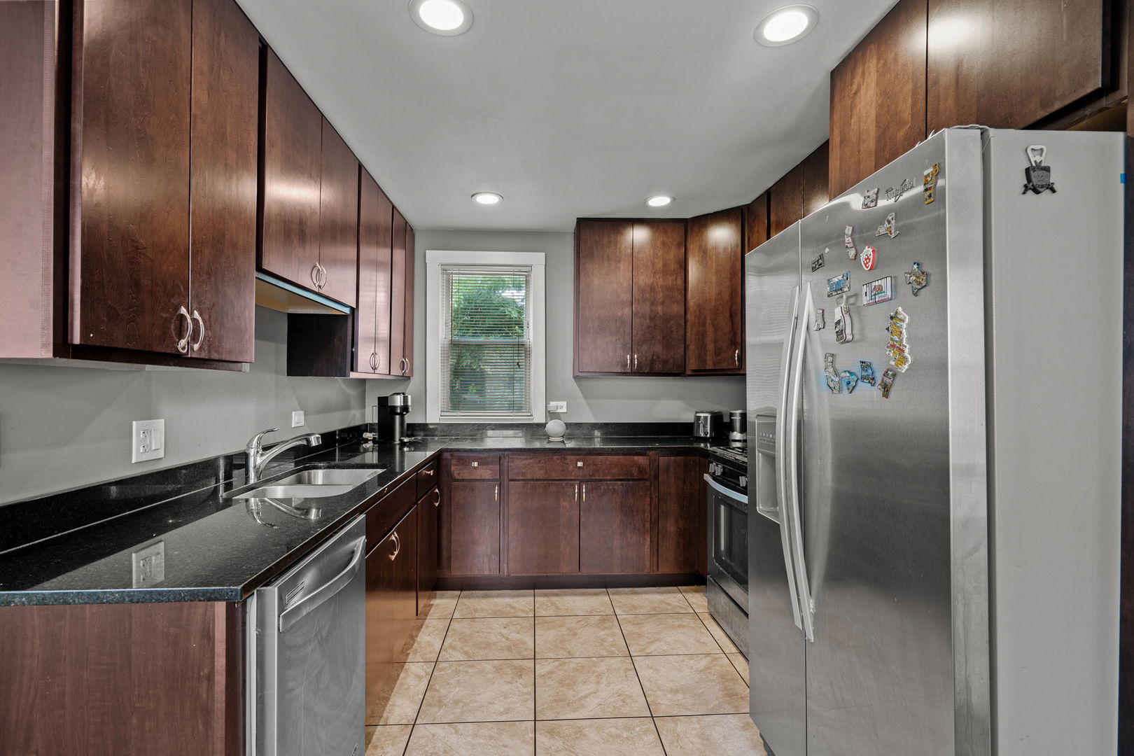 8103 46th Street Lyons, IL 60534 - Photo 8 of 14 a kitchen with granite countertop stainless steel appliances a sink stove and refrigerator