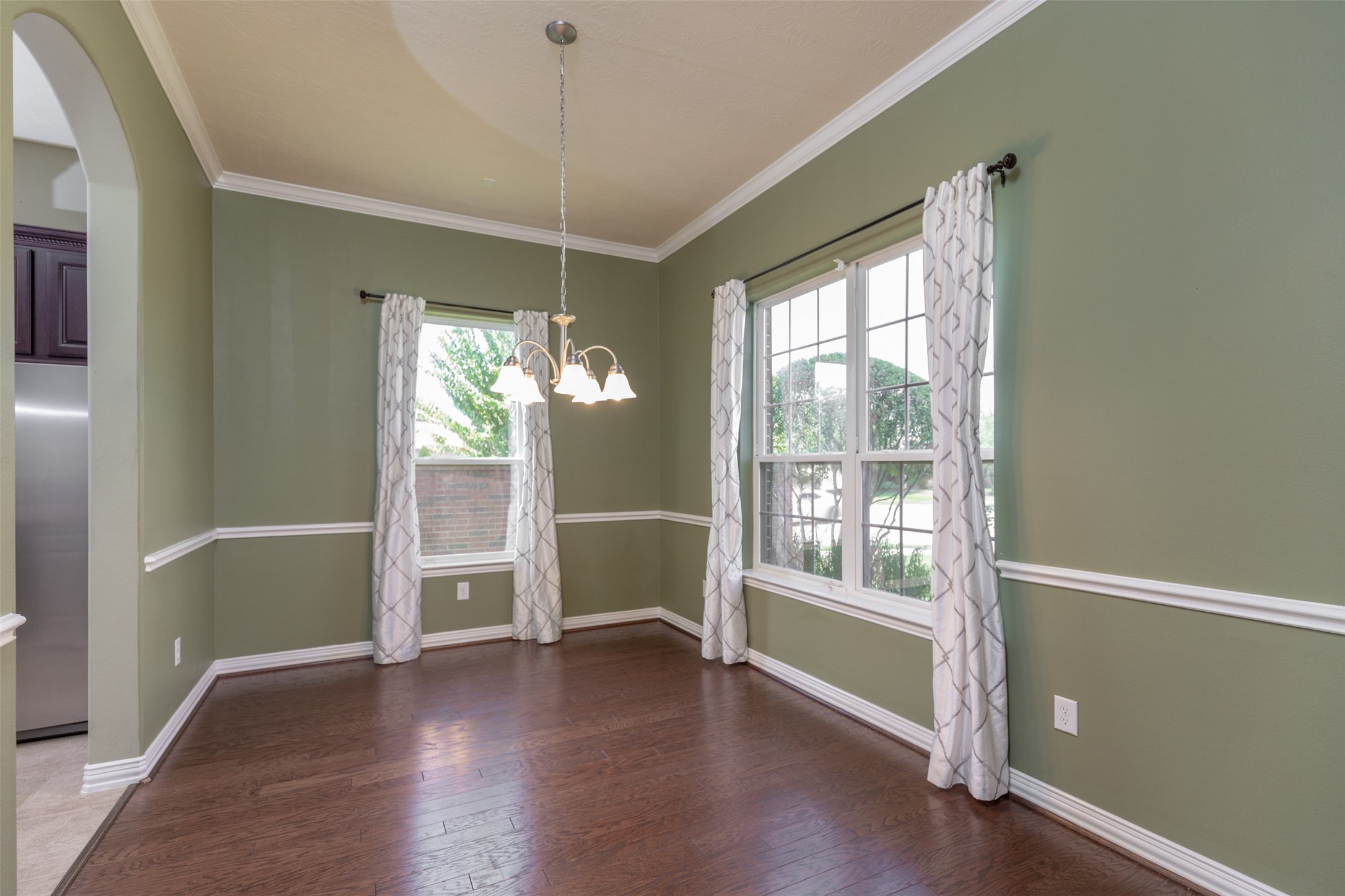 25023 Florina Ranch Drive Katy, TX 77494 - Photo 7 of 12 a view of an empty room with wooden floor and a window