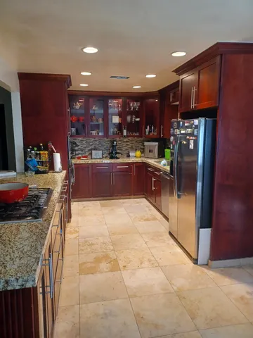 a living room with stainless steel appliances kitchen island granite countertop furniture a rug and a kitchen view