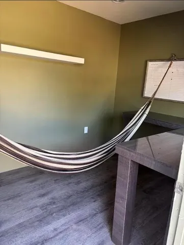 a view of a backyard with plants and a fountain