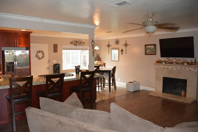 a living room with furniture a flat screen tv and a fireplace