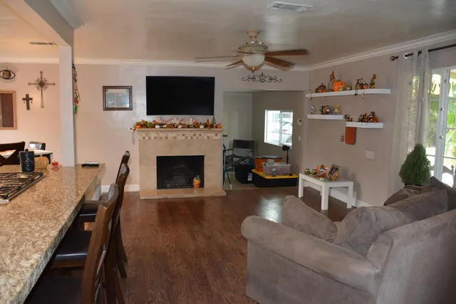 a living room with furniture and wooden floor