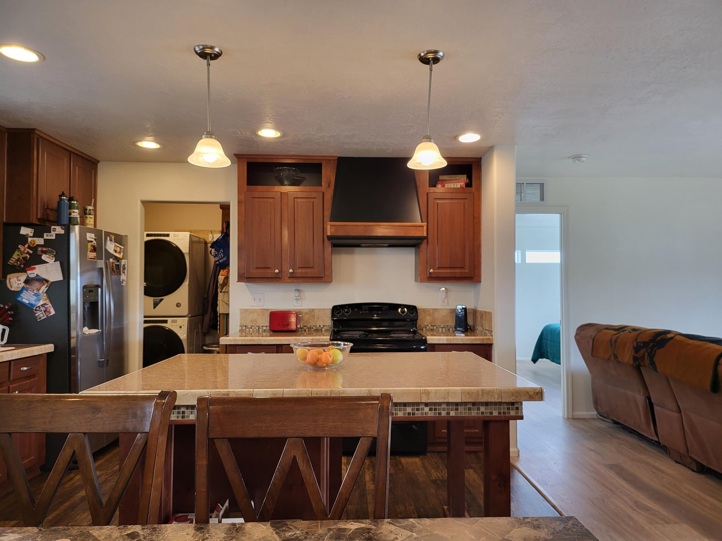 2540 East Gregory Road Central Point, OR 97502 - Photo 7 of 19 a kitchen with stainless steel appliances granite countertop a sink a stove and a wooden floors