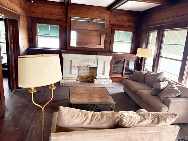 a living room with furniture window and hardwood floor