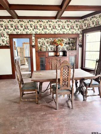 a view of a dining area with furniture and a window