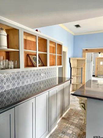 a view of a kitchen with a sink and a large window