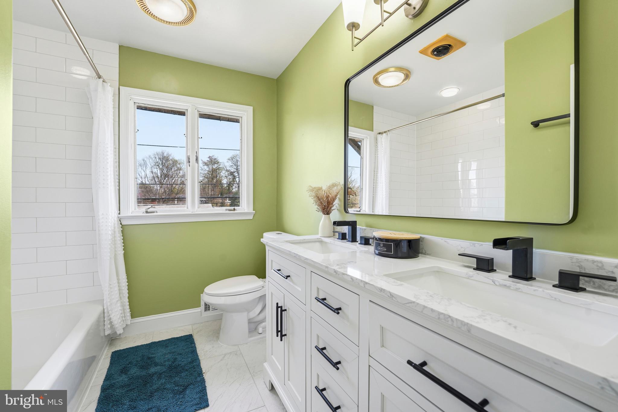 700 Greyrock Drive Silver Spring, MD 20910 - Photo 12 of 48 a bathroom with a granite countertop sink mirror vanity and a toilet