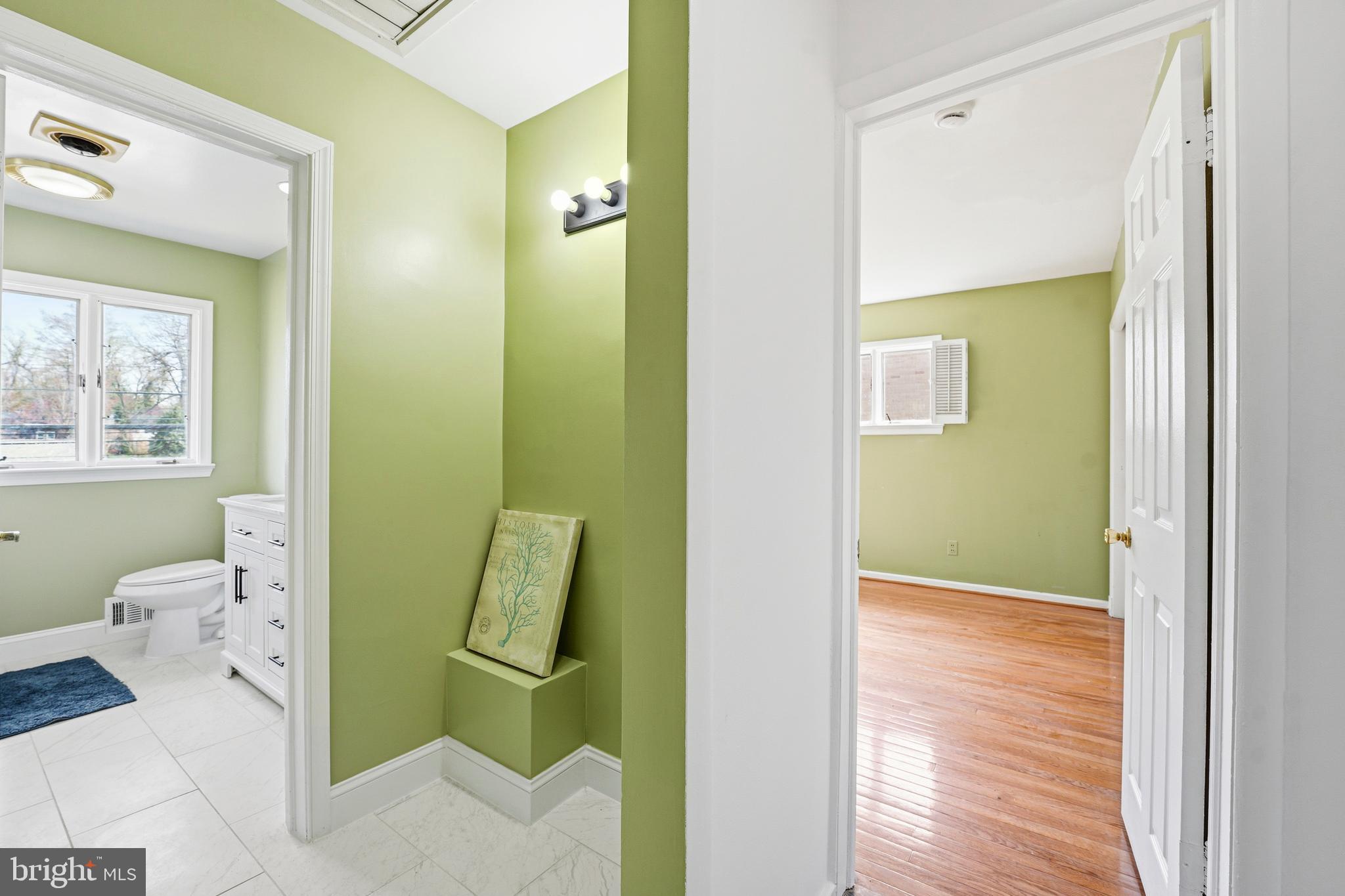 700 Greyrock Drive Silver Spring, MD 20910 - Photo 14 of 48 a bathroom with a toilet sink and mirror