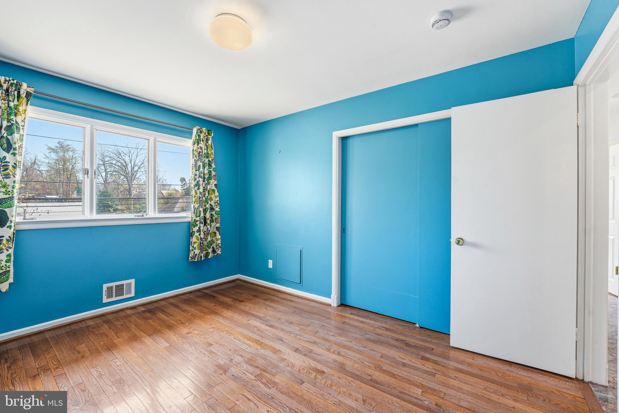 700 Greyrock Drive Silver Spring, MD 20910 - Photo 19 of 48 an empty room with wooden floor and windows