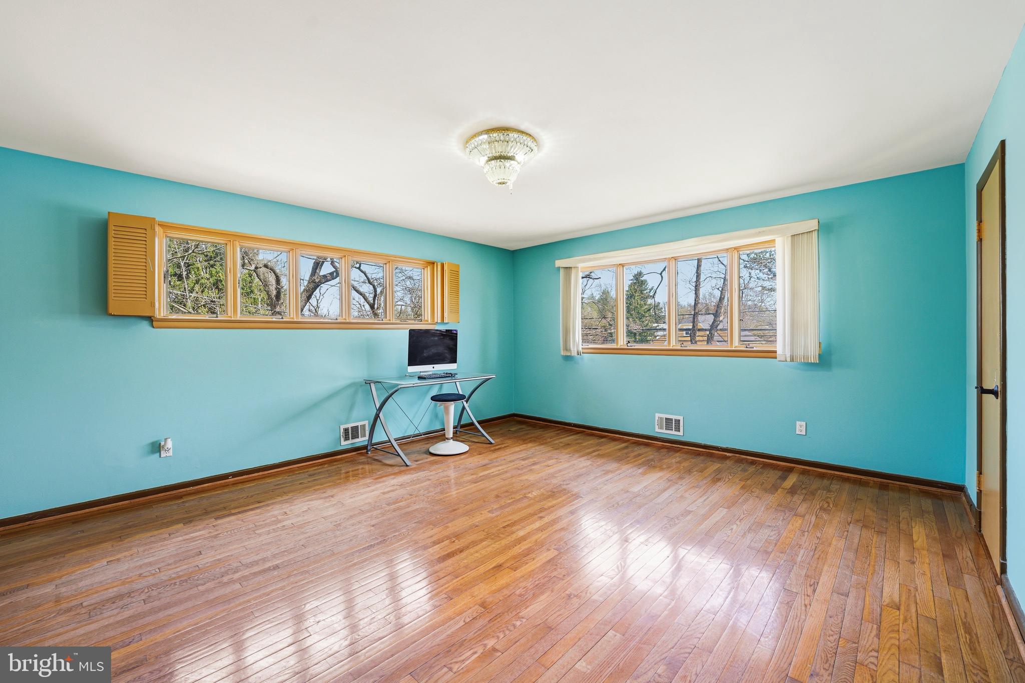 700 Greyrock Drive Silver Spring, MD 20910 - Photo 21 of 48 a view of a room with wooden floor ceiling fan and windows