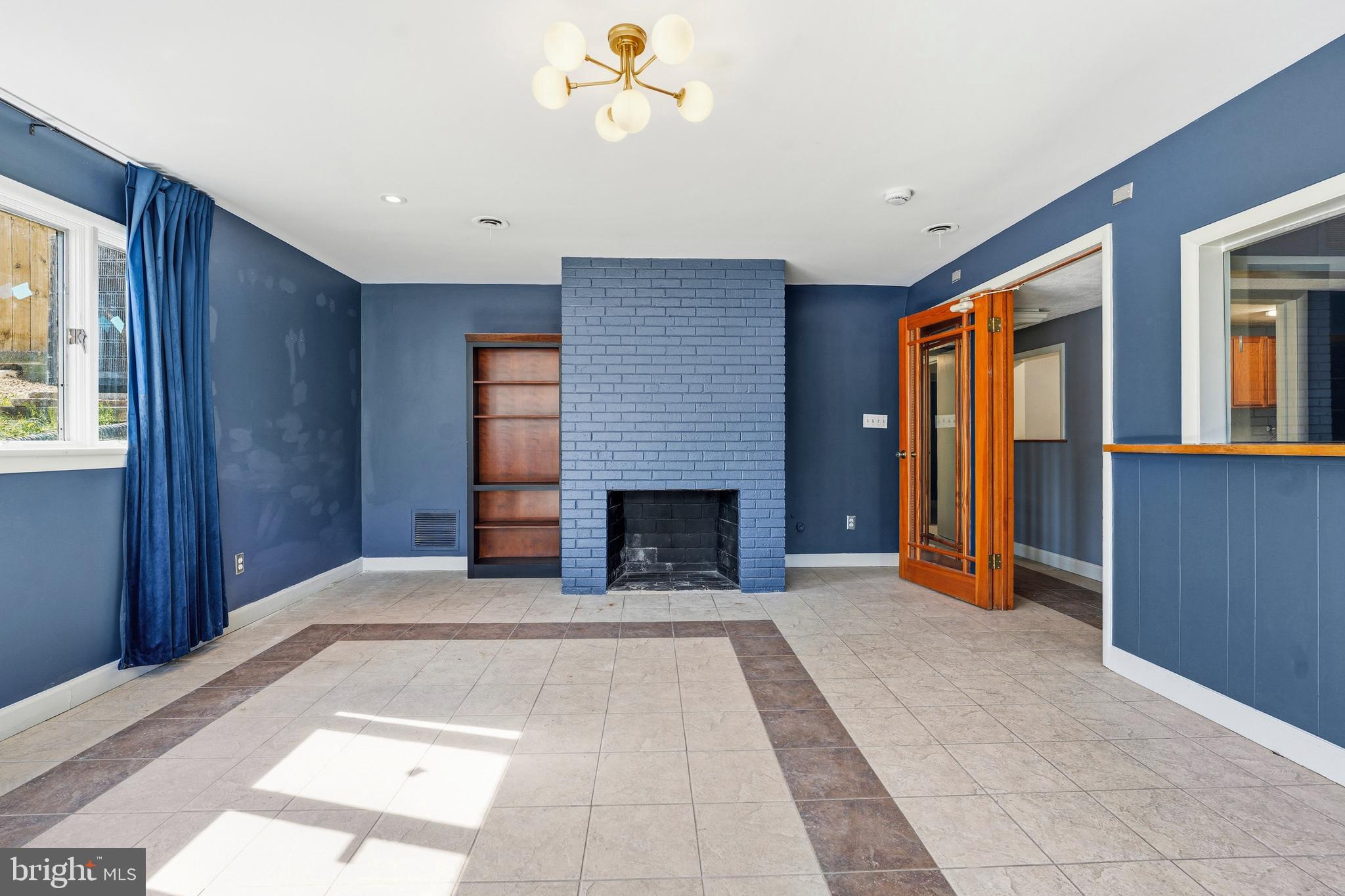 700 Greyrock Drive Silver Spring, MD 20910 - Photo 27 of 48 a view of a livingroom with a fireplace cabinet and windows