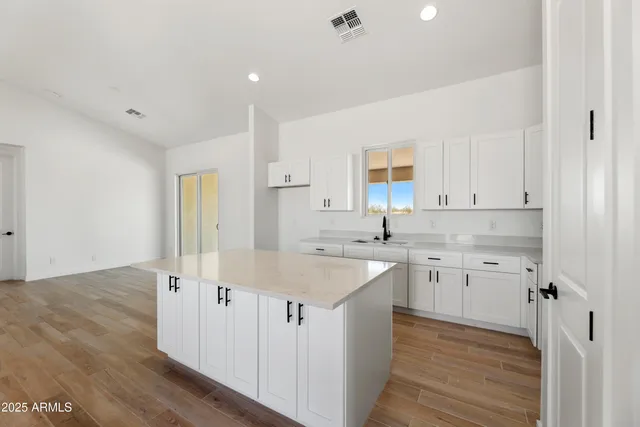 a kitchen with sink cabinets and wooden floor