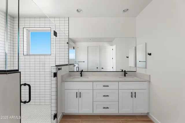 a bathroom with a granite countertop sink mirror and double