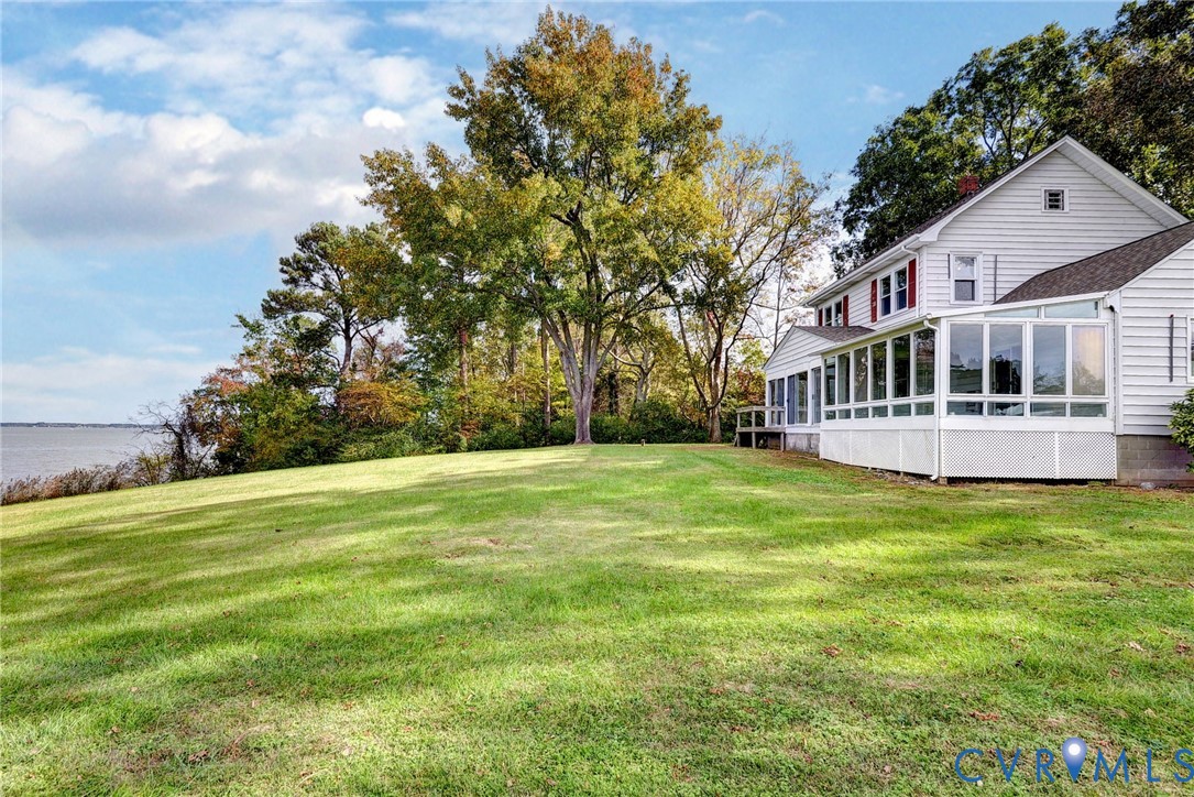 1126 Cloverdale Road Laneview, VA 22504 - Photo 3 of 49 a front view of a house with a yard and trees