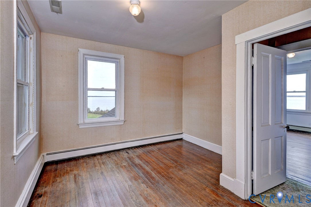 1126 Cloverdale Road Laneview, VA 22504 - Photo 37 of 49 an empty room with wooden floor cabinet and windows