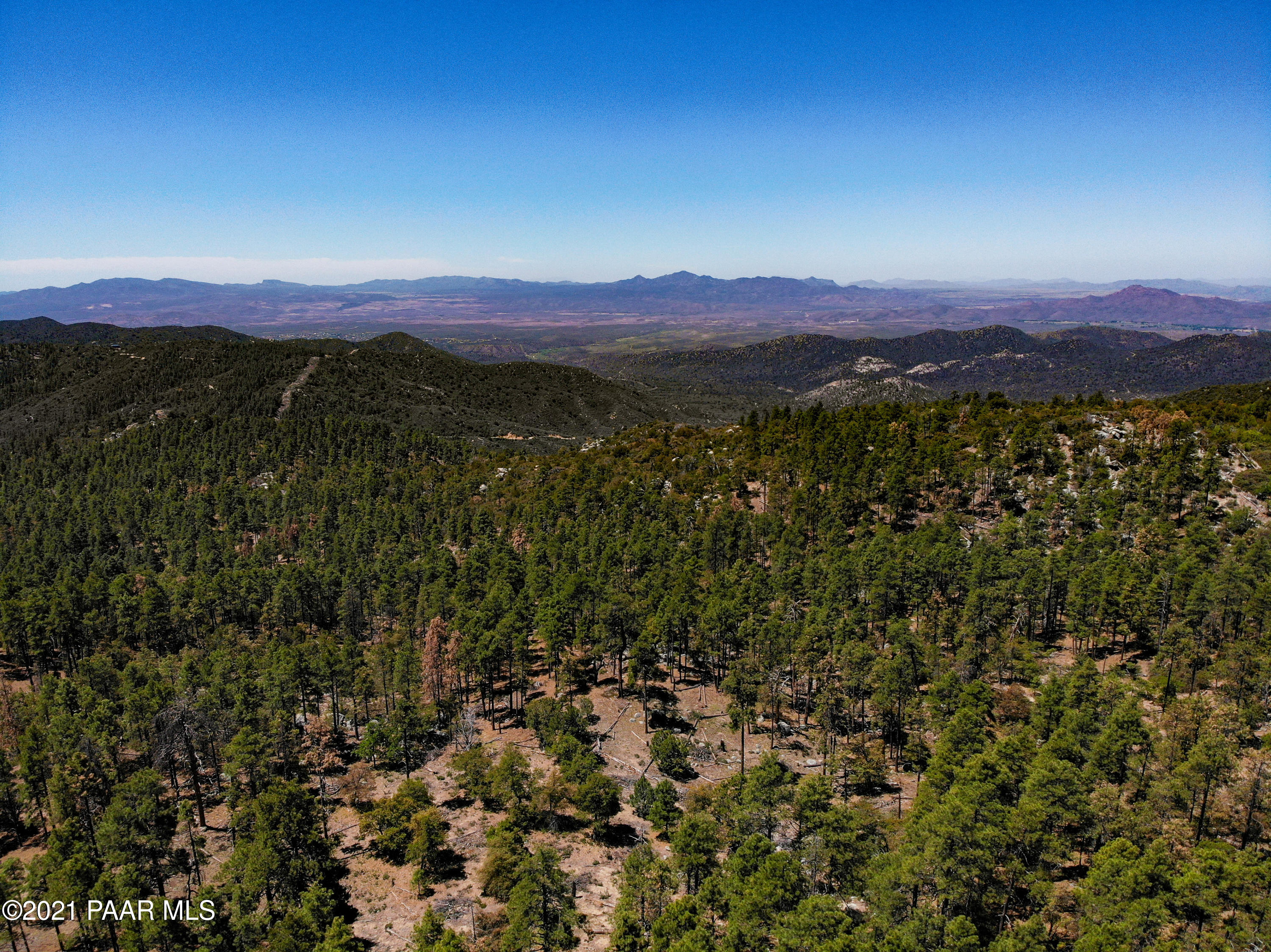 5000 West Copper Basin Road Prescott, AZ 86303 - Photo 1 of 17 a view of a lush green hillside and a houses