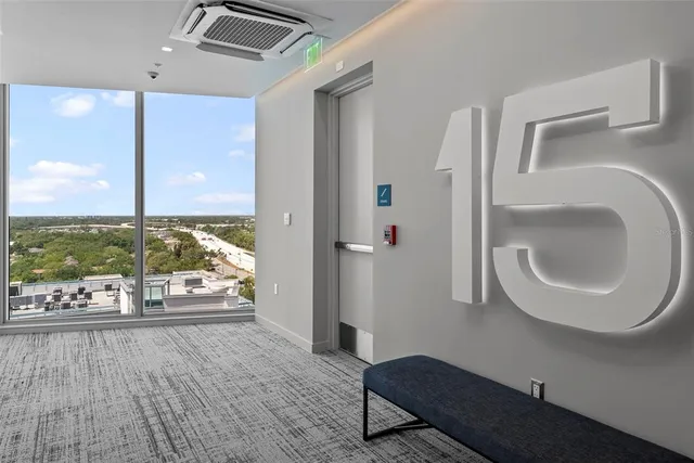 a living room with furniture potted plant and a large window
