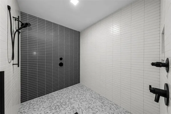 a living room with furniture and a air conditioner vent