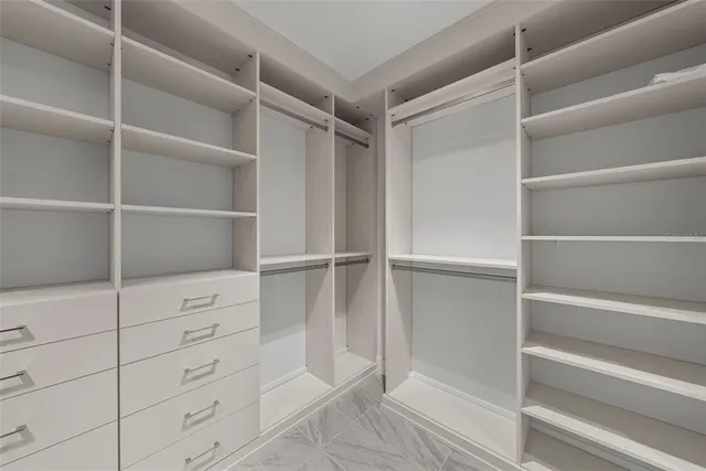 a living room with furniture a flat screen tv and a floor to ceiling window