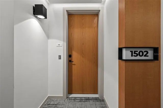 a living room with furniture a rug and a flat screen tv
