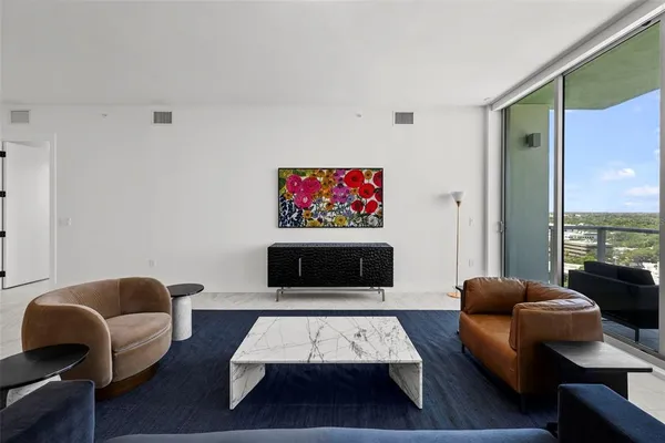 a living room with furniture and large windows