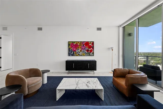 a living room with furniture and large windows