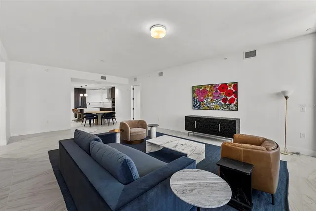 a living room with furniture large window and a table