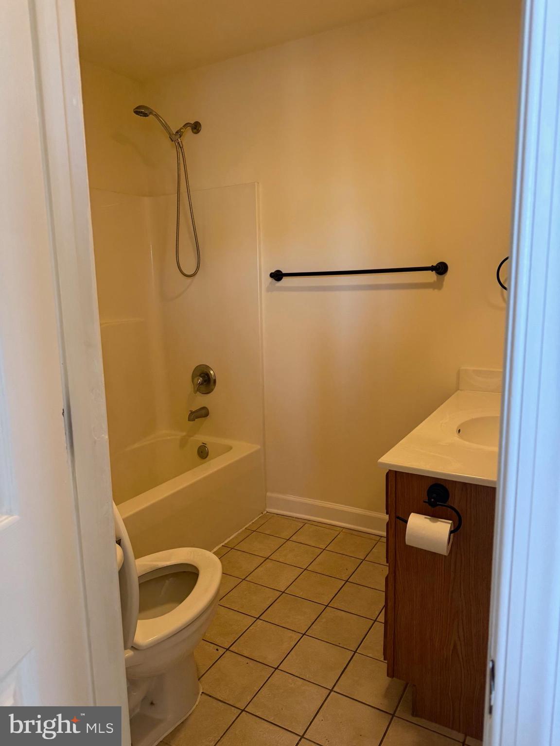 405 1/2 Elm Street Winchester, VA 22601 - Photo 11 of 16 a bathroom with a granite countertop bathtub shower sink and toilet