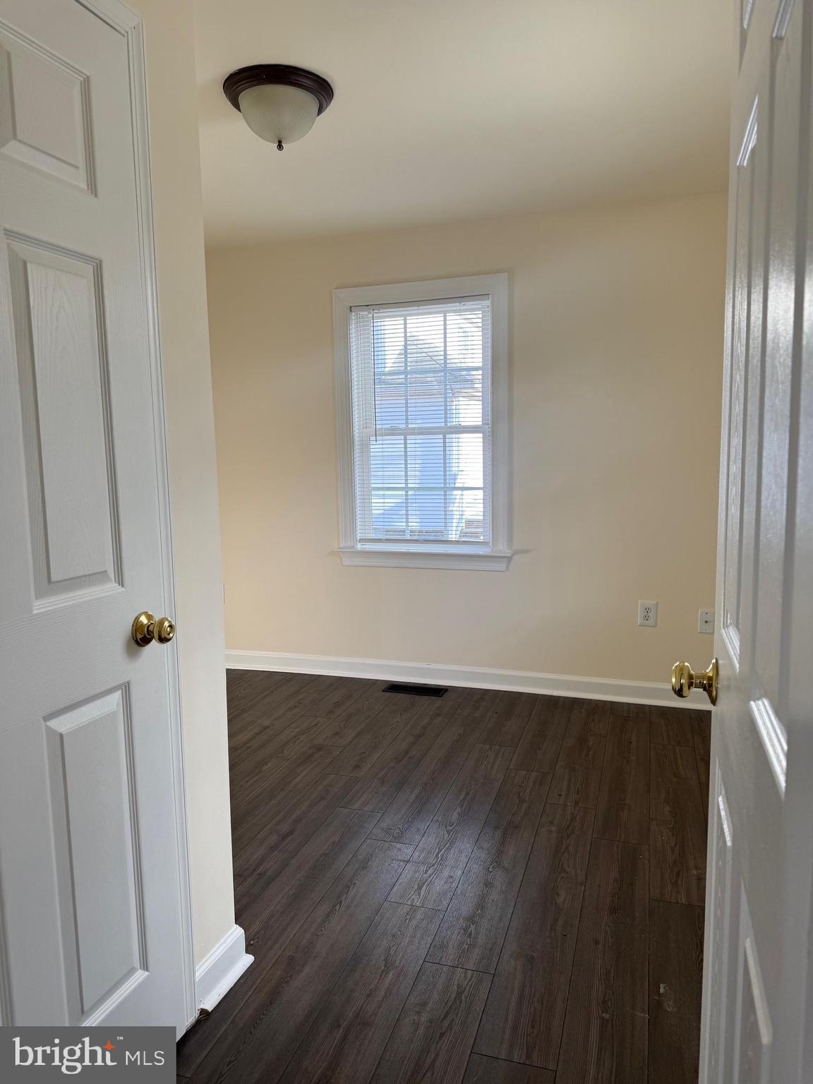 405 1/2 Elm Street Winchester, VA 22601 - Photo 2 of 16 an empty room with wooden floor and windows