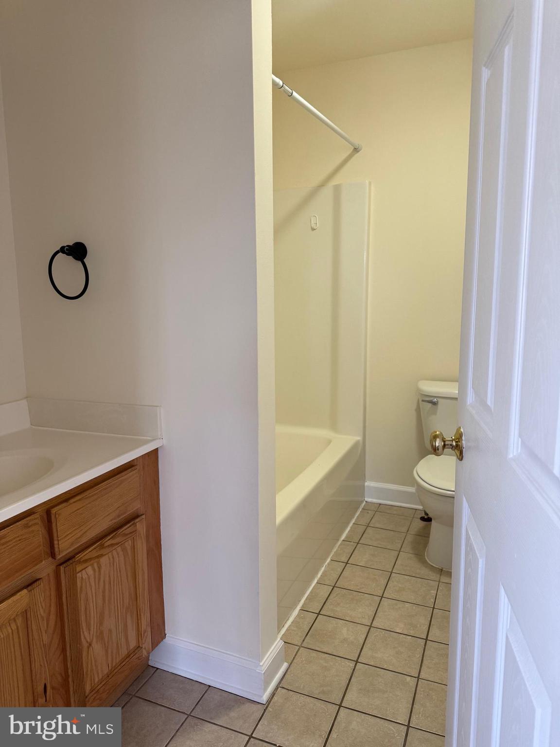 405 1/2 Elm Street Winchester, VA 22601 - Photo 4 of 16 a bathroom with a granite countertop sink a toilet and shower