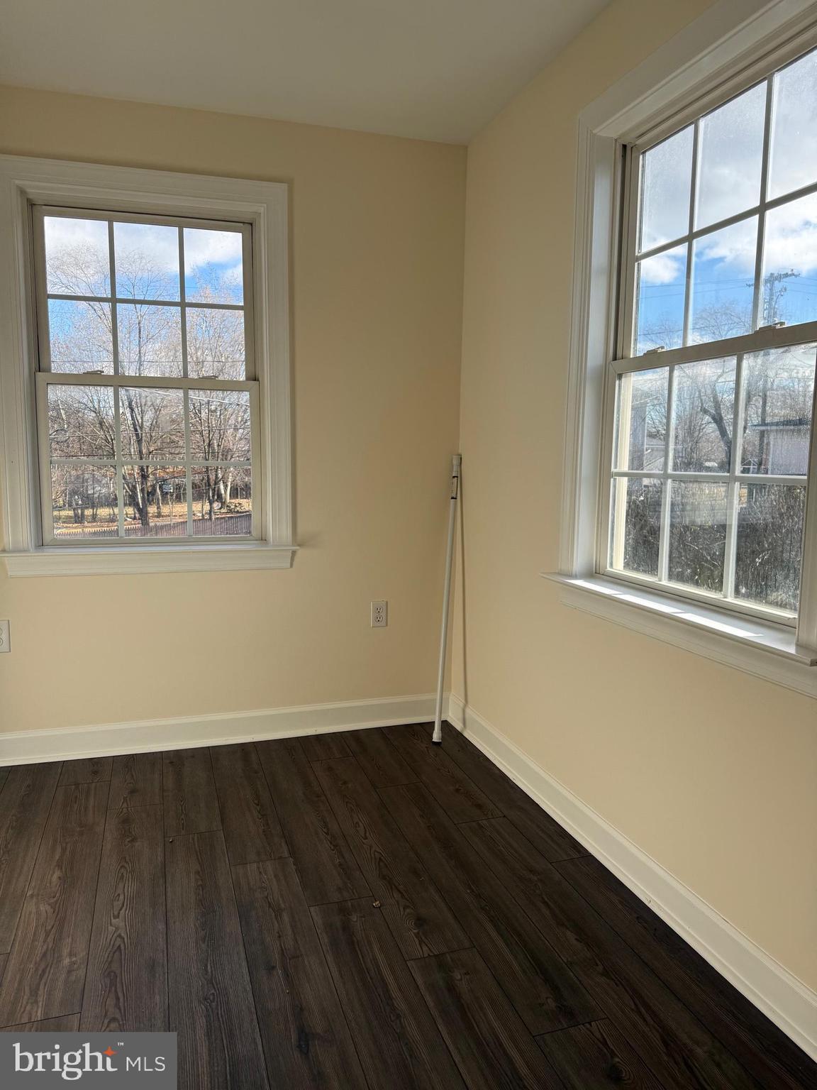405 1/2 Elm Street Winchester, VA 22601 - Photo 9 of 16 an empty room with wooden floor and windows