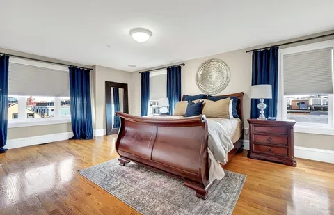 a bed room with a bed mirror and a window