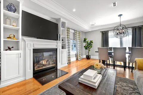 a living room with furniture fireplace and flat screen tv