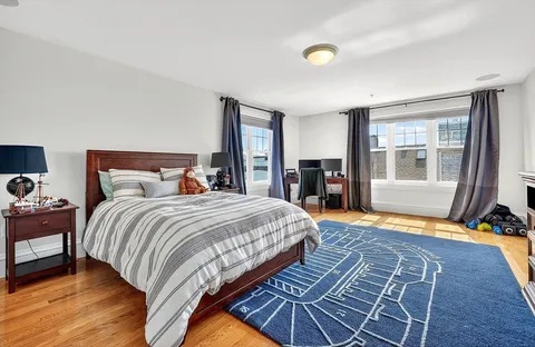 a bedroom with bed and wooden floor