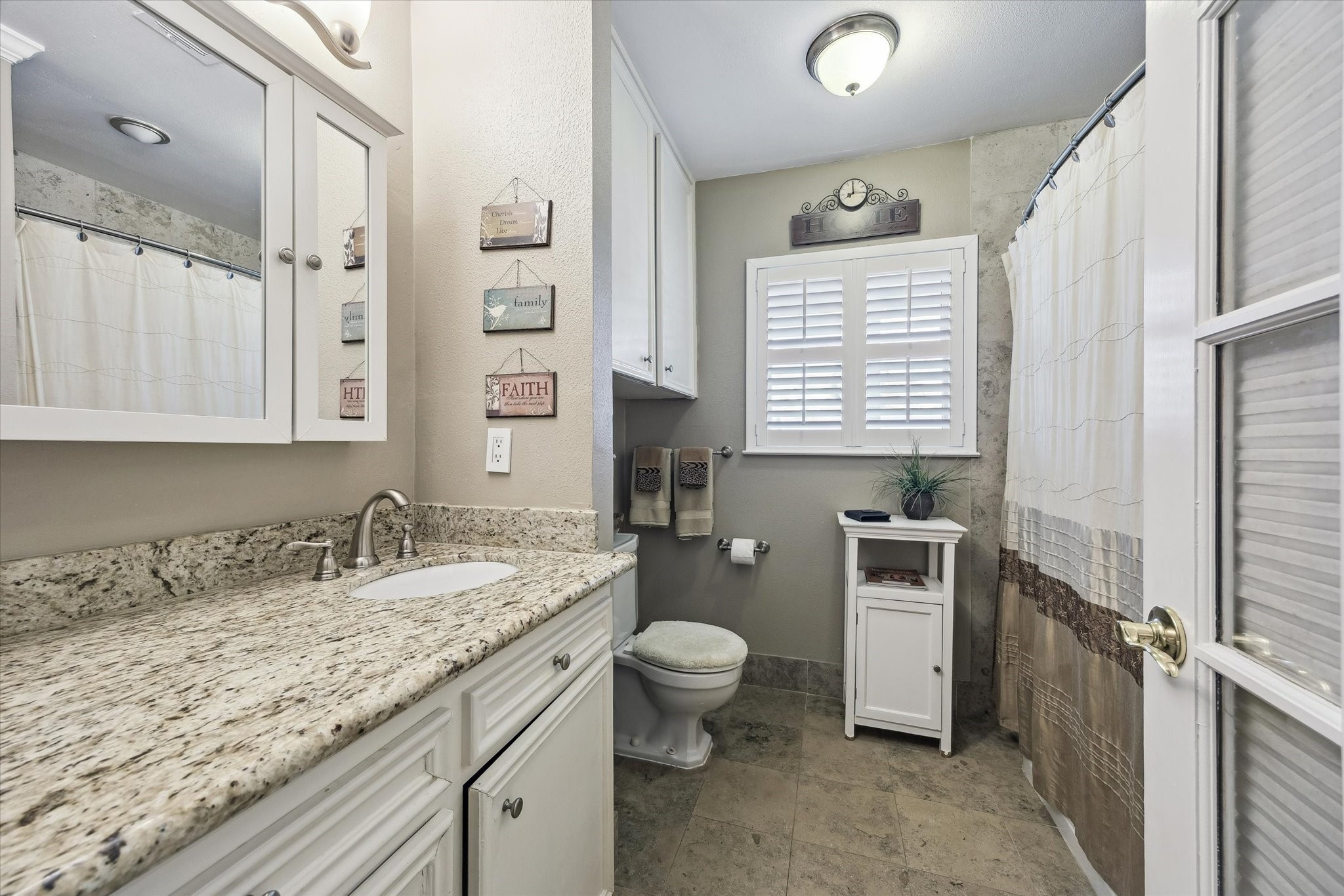 1423 Richelieu Lane Houston, TX 77018 - Photo 19 of 46 a bathroom with a granite countertop sink toilet and shower