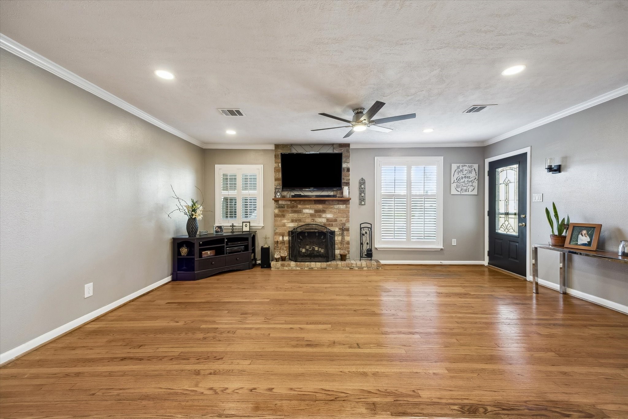 1423 Richelieu Lane Houston, TX 77018 - Photo 5 of 46 a view of a livingroom with a fireplace a chandelier and wooden floor