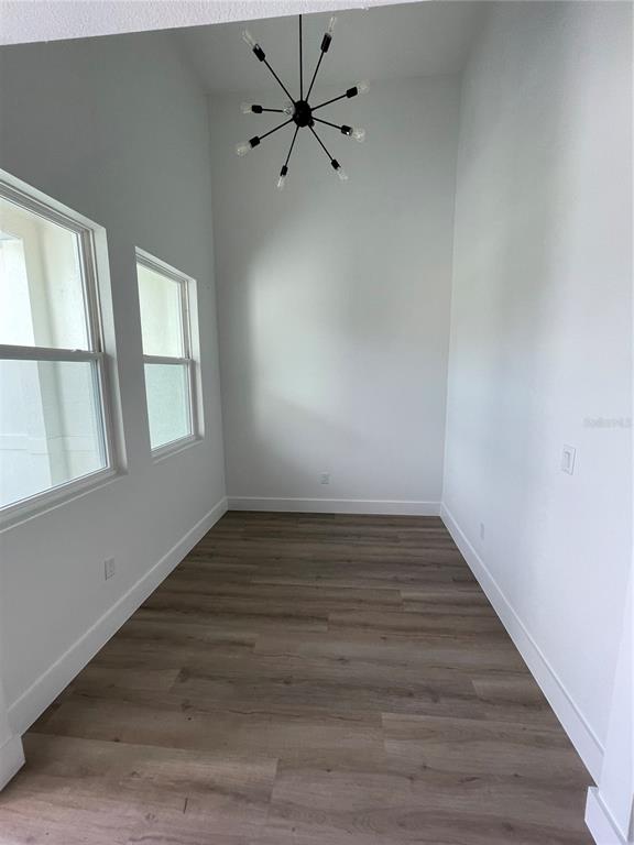 41719 Aspen Street Eustis, FL 32736 - Photo 12 of 52 a view of an empty room with wooden floor and fan