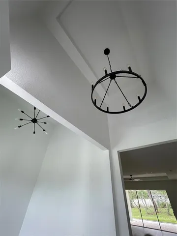 a kitchen with a refrigerator a stove a sink and white cabinets