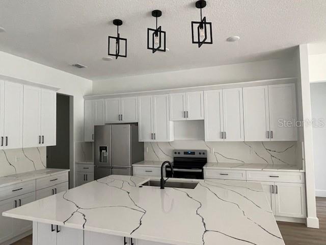 41719 Aspen Street Eustis, FL 32736 - Photo 15 of 52 a kitchen with a refrigerator and cabinets