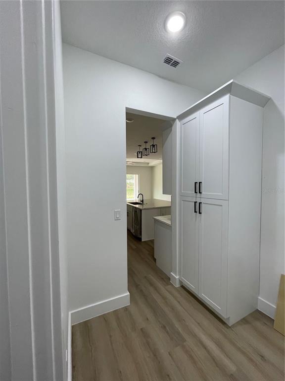 41719 Aspen Street Eustis, FL 32736 - Photo 19 of 52 a view of a hallway with wooden floor