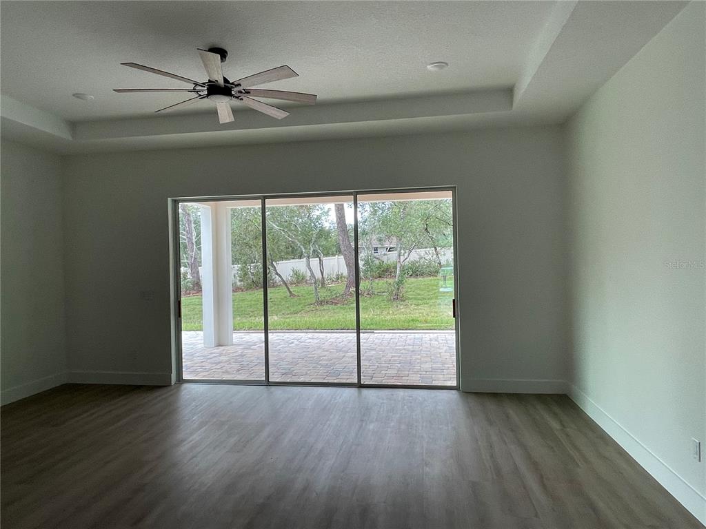 41719 Aspen Street Eustis, FL 32736 - Photo 21 of 52 a view of an empty room with wooden floor and a window