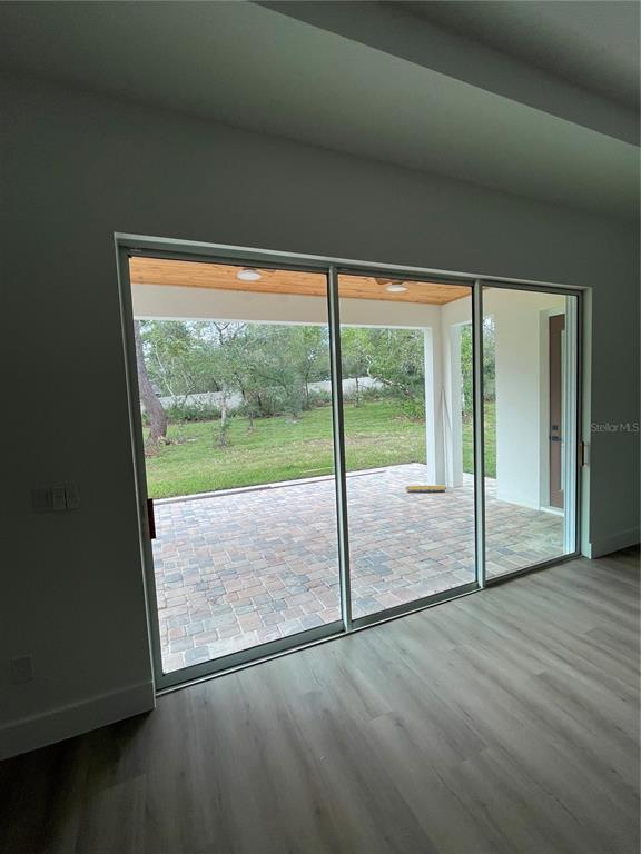 41719 Aspen Street Eustis, FL 32736 - Photo 22 of 52 a view of empty room with wooden floor and sliding door