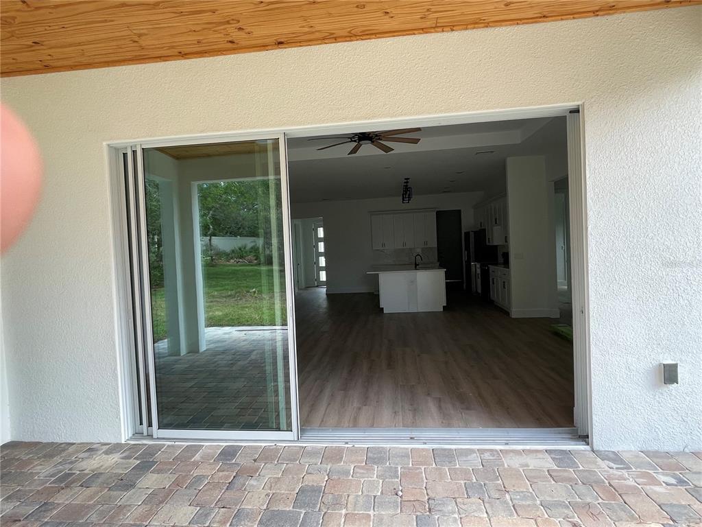41719 Aspen Street Eustis, FL 32736 - Photo 27 of 52 a view of a hallway with wooden floor and a living room