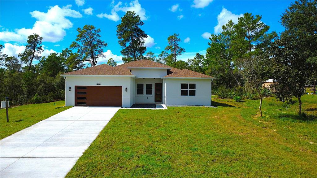 41719 Aspen Street Eustis, FL 32736 - Photo 4 of 52 a front view of a house with garden